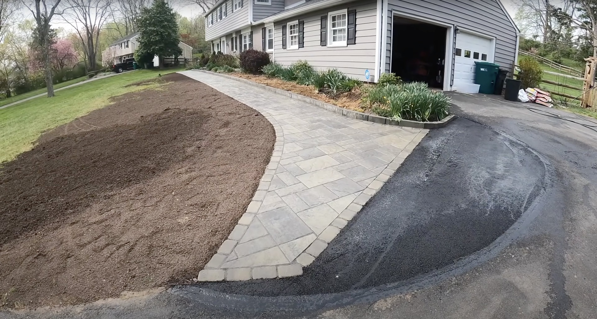 Beautiful paver walkway and driveway installation with curved design and professional landscaping integration
